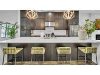 Modern kitchen with dark cabinetry, quartz countertops, and stainless steel appliances at 1107 Briar Cove Cir, Atlanta, GA 30329