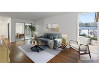 Bright living room featuring hardwood floors, modern decor, and sliding glass doors to a patio at 3242 Henderson Mill Rd # 3, Atlanta, GA 30341