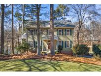 Two-story house with green siding, shutters, and a large yard at 1925 Annwicks Dr, Marietta, GA 30062