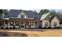 Two-story brick home with a front porch and landscaped yard at 213 Cades Ct, Mcdonough, GA 30252