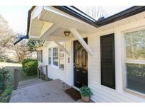 Inviting front entrance with a black door, potted plant, and stylish exterior at 272 Old Sudie Rd, Hiram, GA 30141