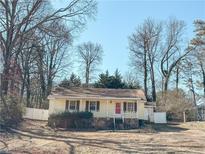 Ranch style home with a red door, front porch, and a fenced yard at 2849 Knotty Pine Ct, Buford, GA 30519