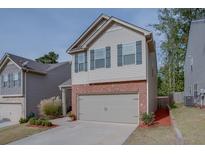 Two-story house with brick and siding exterior, two-car garage, and landscaping at 5138 Mcever View Dr, Sugar Hill, GA 30518