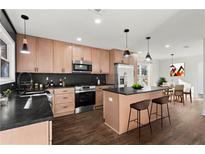 Bright kitchen featuring stainless appliances, dark backsplash, breakfast bar, and modern pendant lighting at 1956 Gober Se Ave, Smyrna, GA 30080