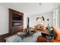 Modern living room featuring sleek decor, a fireplace, and a large screen TV at 1956 Gober Se Ave, Smyrna, GA 30080