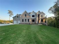 Two-story brick home with a large front yard and three-car garage at 208 Indian Hills Trail, Marietta, GA 30068