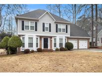 Two-story house with gray siding, brick accents, and a two-car garage at 4794 Deer Chase, Powder Springs, GA 30127