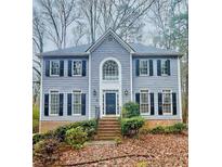 Two-story house with gray siding, black shutters, and a brick walkway at 295 Creekview Trl, Fayetteville, GA 30214