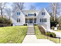 Beautiful two-story home with gray siding, manicured lawn, and a welcoming front porch at 2624 Forrest Ne Way, Atlanta, GA 30305