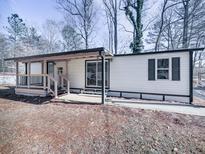 Updated mobile home with covered porch and landscaped yard at 337 Theodore Cox Cir, Canton, GA 30114