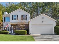 Two-story house with attached garage and landscaped lawn at 5785 Stephens Mill Dr, Sugar Hill, GA 30518