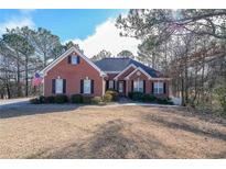 Brick house with a large front yard and mature trees at 1765 Rubye Lee Ln, Dacula, GA 30019