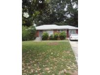 Brick ranch house with a spacious lawn and mature trees at 2244 Alpha Dr, Decatur, GA 30032