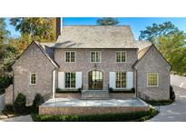 Brick home with a gabled roof, white shutters, and a large front porch at 2515 Habersham Nw Rd, Atlanta, GA 30305