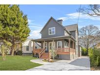 Gray farmhouse exterior with front porch, landscaping, and driveway at 3378 Bachelor St, Atlanta, GA 30344