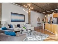 Open living area with hardwood floors, exposed ductwork, and stylish furniture at 3235 Roswell Ne Rd # 615, Atlanta, GA 30305