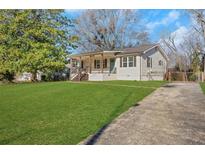 Charming ranch home with a spacious lawn and long driveway at 247 Fowler Ne Cir, Marietta, GA 30060
