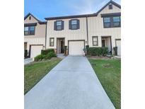 Two-story townhome with attached garage and landscaped lawn at 6421 Mountain Home Way, Mableton, GA 30126