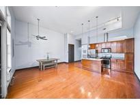 Open concept living space with hardwood floors, modern kitchen, and island at 1195 Milton Se Ter # 2305, Atlanta, GA 30315