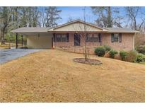 Brick ranch home with carport and mature trees at 1151 Mohican Trl, Stone Mountain, GA 30083