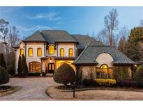 Stunning brick home with a large driveway and manicured landscaping at 1696 Windsor Ne Pkwy, Atlanta, GA 30319