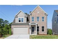 Two-story brick home with gray siding, attached garage, and landscaped lawn at 412 Newland Way, Acworth, GA 30102