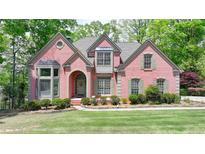 Charming two-story brick home with manicured lawn and mature trees, offering great curb appeal in a desirable neighborhood at 5915 Masters Club Dr, Suwanee, GA 30024