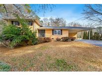 Ranch style home with carport and mature landscaping at 798 Woodvalley Sw Rd, Mableton, GA 30126
