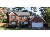 Brick two-story house with attached garage and landscaped yard at 2206 Baker Carter Dr, Loganville, GA 30052