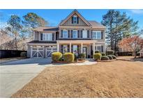 Two-story house with gray siding, stone accents, and a landscaped yard at 464 Rockford Pass, Marietta, GA 30064