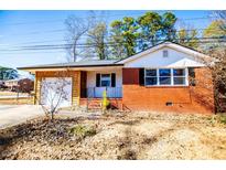 Brick ranch house with a spacious yard and attached garage at 6531 Temple St, Lithia Springs, GA 30122