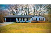 Charming single-story home with a two-car garage and a well-maintained front yard at 5409 Mill Valley Dr, Douglasville, GA 30135