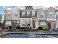 Three-story townhome with modern facade and front yard at 871 Ambient Sw Way, Atlanta, GA 30331