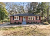 Brick ranch house with a landscaped yard at 305 Brookwood Dr, Marietta, GA 30064