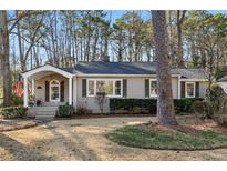 Charming ranch home with a covered porch and well-manicured lawn at 2105 Clairmont Ne Ter, Atlanta, GA 30345