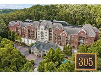 Luxury condo building with upscale exterior and landscaping at 3280 Stillhouse Se Ln # 305, Atlanta, GA 30339