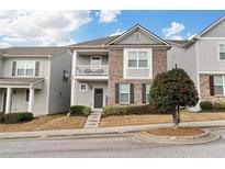 Charming two-story home with a brick facade and a second story balcony, offering curb appeal and outdoor living space at 840 Regal Ln, Atlanta, GA 30331