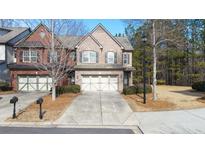 Brick front exterior of charming townhome with two-car garage at 4640 Hastings Ter, Alpharetta, GA 30005