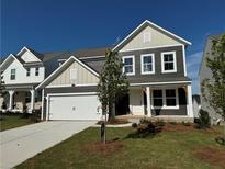 Charming two-story home with a well-manicured lawn and an attached two-car garage at 110 Okeechobee Way, Braselton, GA 30548