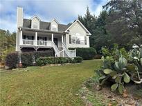 Two-story house with a wraparound porch and a landscaped yard at 166 Greentree Trl, Temple, GA 30179
