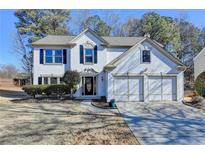 Two-story house with a two-car garage and manicured lawn at 1931 Abinger Way, Lawrenceville, GA 30043