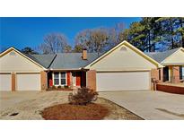 Inviting exterior of charming yellow-sided townhome with two-car garage at 6146 Douglas Manor Ct, Douglasville, GA 30134