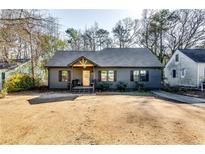 Charming craftsman style home with gray siding, modern door, and landscaped yard at 2508 Connally Dr, East Point, GA 30344