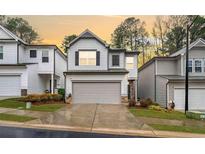 Charming two-story home featuring a well-maintained lawn and a convenient two-car garage at 319 Pinewood Dr, Woodstock, GA 30189