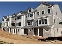 New townhomes with gray siding, brick accents and meticulous architectural details at 1980 Flying Scotsman Dr # 10, Kennesaw, GA 30144