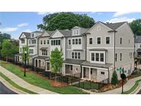 Row of newly constructed townhomes with varied neutral siding, manicured lawns, and black metal fences at 1980 Flying Scotsman Dr # 10, Kennesaw, GA 30144