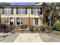 Charming townhome featuring brick facade, black shutters, and private front patio with outdoor seating at 1634 Ponce De Leon Ne Ave # 503, Atlanta, GA 30307