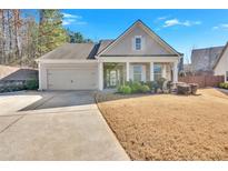 Charming one-story house with gray siding, a two-car garage, and a well-manicured lawn at 501 Olympic Way, Acworth, GA 30102