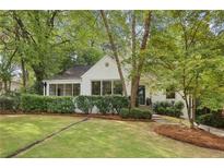 White brick home with manicured lawn and mature trees at 521 E Wesley Ne Rd, Atlanta, GA 30305