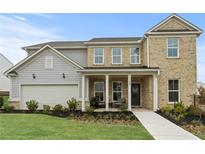 Two-story house with gray and beige siding, a covered porch, and a landscaped lawn at 106 Delilah St, Mcdonough, GA 30252